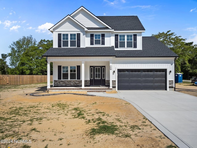 view of front facade with a garage and a porch