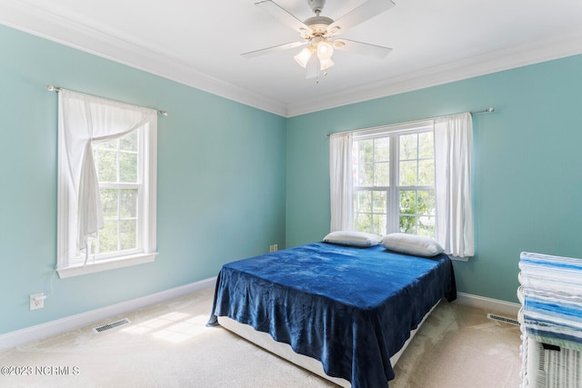 bedroom featuring light colored carpet, ornamental molding, and multiple windows