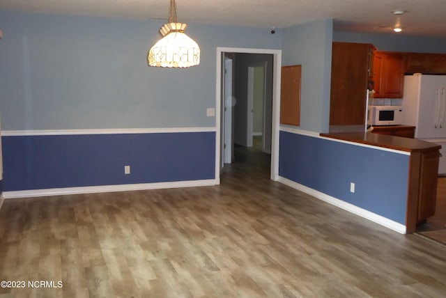 kitchen with dark hardwood / wood-style floors and decorative light fixtures