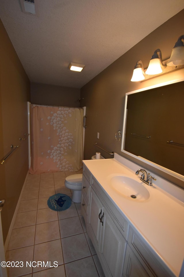 bathroom featuring tile floors, toilet, a textured ceiling, and vanity