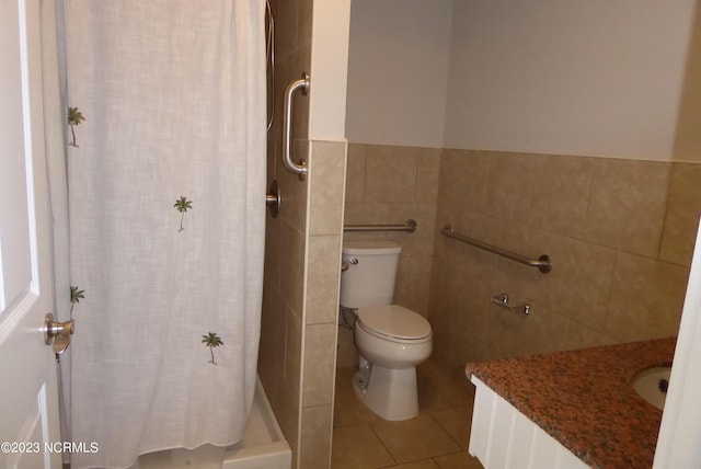 bathroom featuring tile walls, tile floors, toilet, and vanity