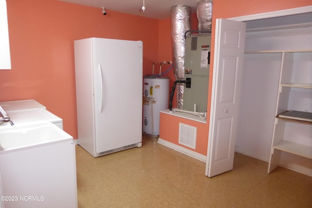 interior space with washing machine and dryer and water heater