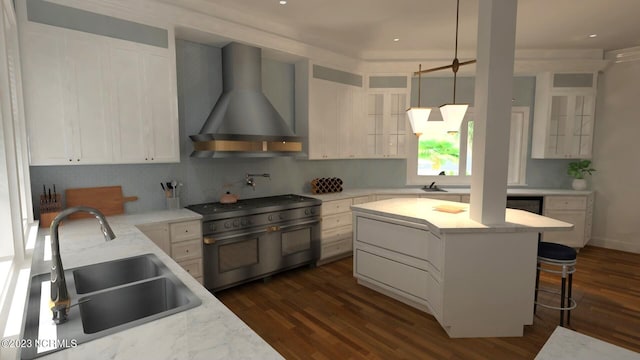 kitchen with a sink, range with two ovens, wall chimney exhaust hood, dark wood finished floors, and backsplash