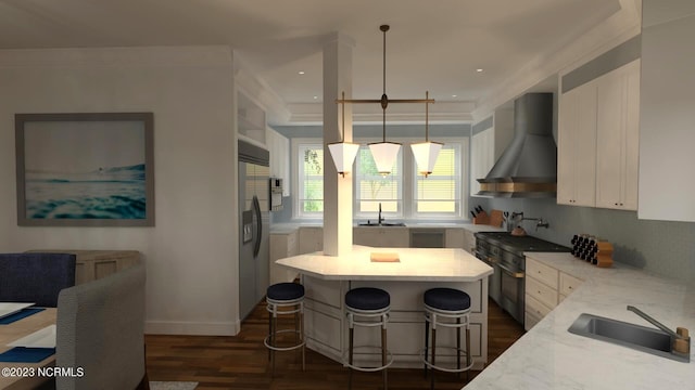 kitchen featuring wall chimney exhaust hood, high end appliances, a sink, dark wood-style floors, and white cabinetry