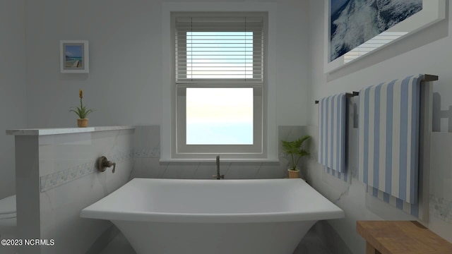 full bathroom with tile walls, healthy amount of natural light, a freestanding bath, radiator heating unit, and toilet