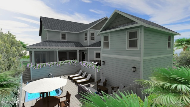 rear view of property with a shingled roof, outdoor dining space, and a wooden deck