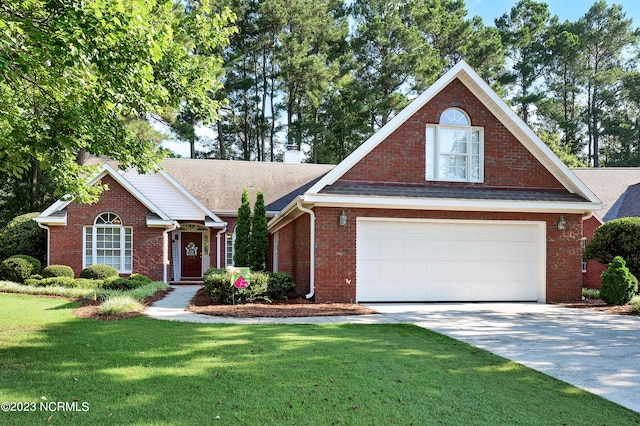 view of front facade with a front yard and a garage