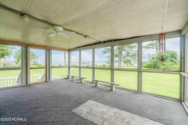 unfurnished sunroom with ceiling fan