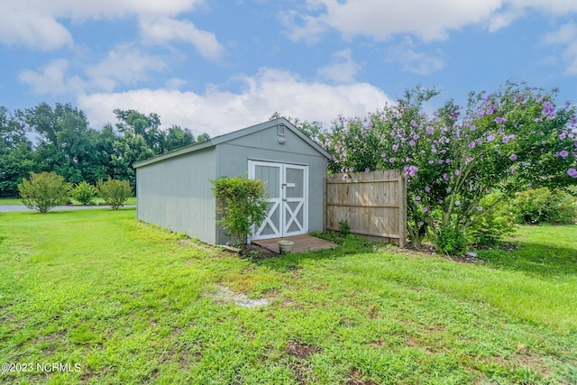 view of outbuilding featuring a yard