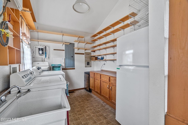 laundry room with electric panel, separate washer and dryer, and sink