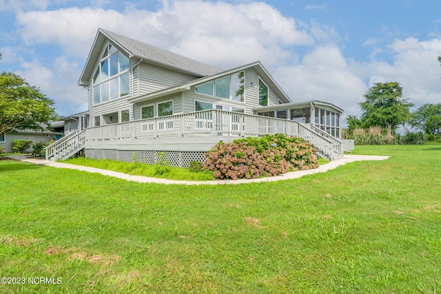 view of side of home featuring a lawn and a deck