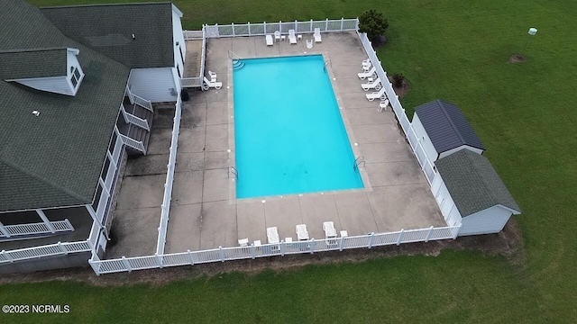 view of pool with a yard