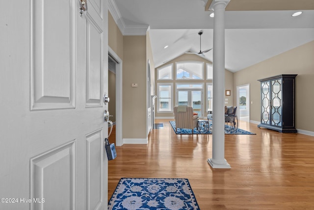 foyer entrance featuring ornate columns, french doors, lofted ceiling, and light wood-type flooring