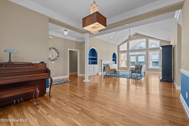 interior space with decorative columns, crown molding, ceiling fan, and light hardwood / wood-style floors