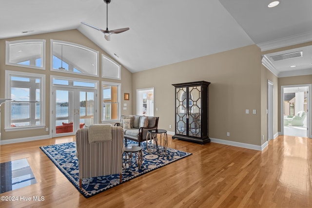 living room with ceiling fan, french doors, light hardwood / wood-style flooring, high vaulted ceiling, and ornamental molding