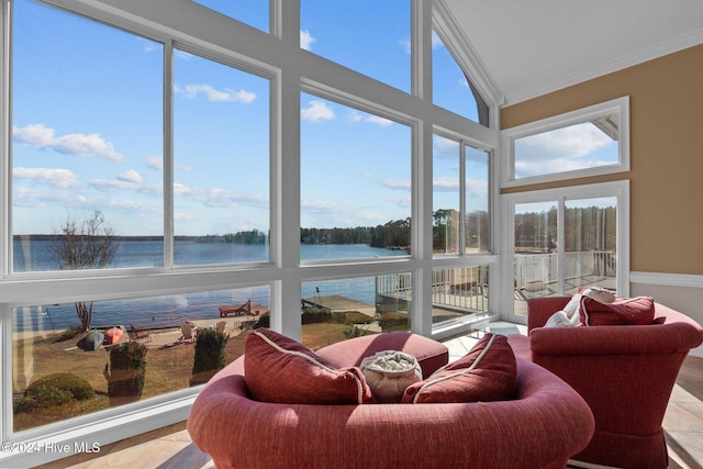 sunroom featuring a water view