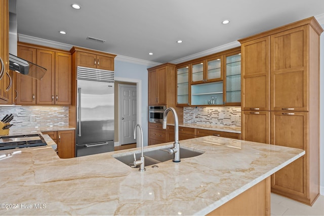 kitchen featuring tasteful backsplash, light stone counters, sink, and stainless steel appliances