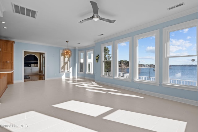 interior space with ceiling fan, plenty of natural light, a water view, and crown molding