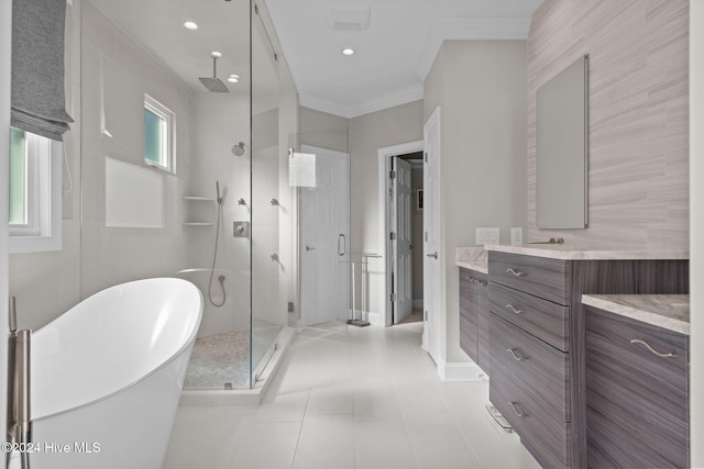 bathroom with tile patterned floors, vanity, crown molding, and shower with separate bathtub