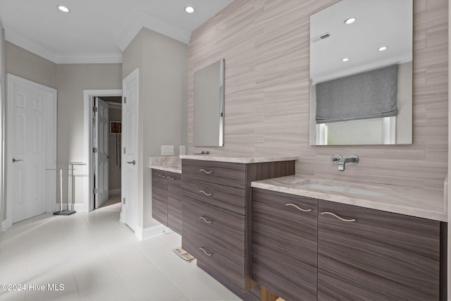 bathroom featuring tile patterned floors, vanity, ornamental molding, and tile walls