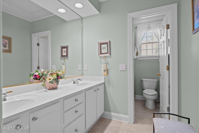 bathroom featuring tile patterned flooring, vanity, toilet, and ornamental molding