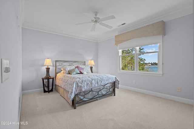 bedroom with ceiling fan, light colored carpet, and crown molding