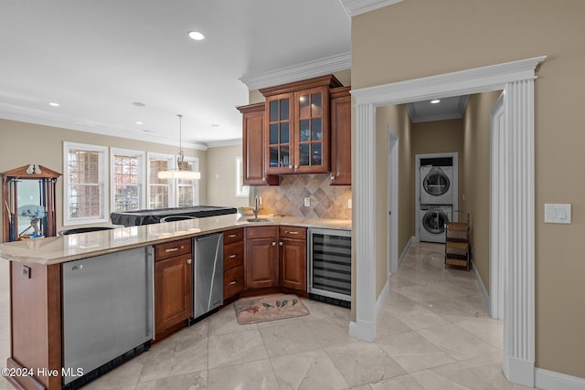 kitchen featuring crown molding, stacked washing maching and dryer, kitchen peninsula, and beverage cooler