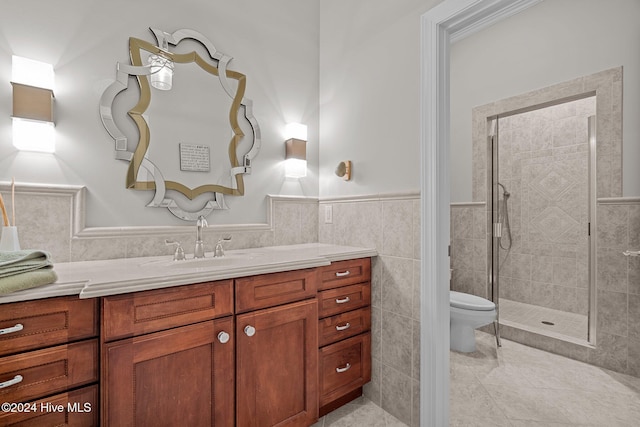 bathroom featuring vanity, tiled shower, tile walls, tile patterned flooring, and toilet