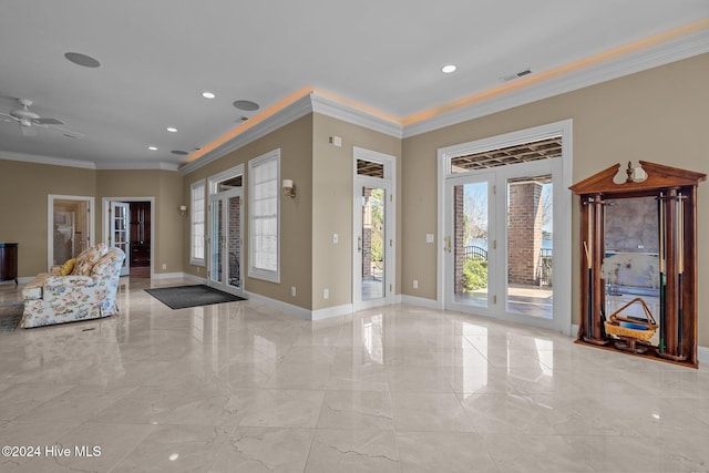 foyer entrance with crown molding and ceiling fan