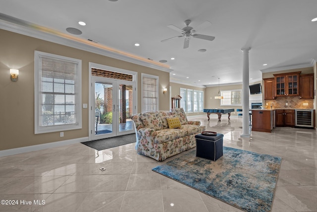 living room with french doors, beverage cooler, billiards, decorative columns, and ornamental molding