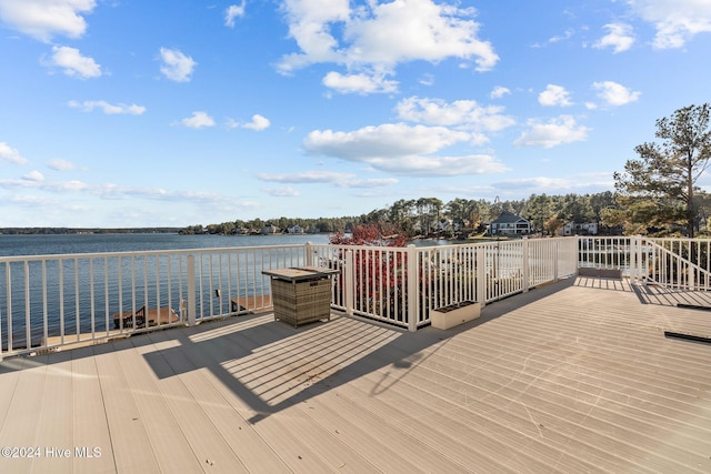 dock area featuring a deck with water view