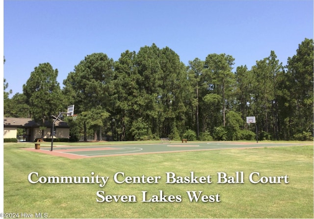 view of sport court featuring a yard