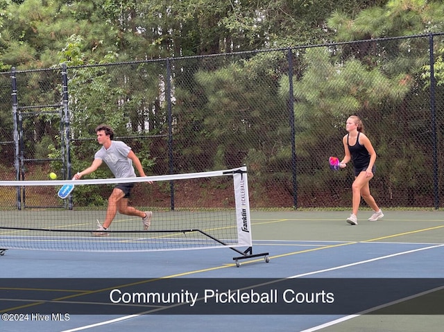 view of tennis court featuring basketball court