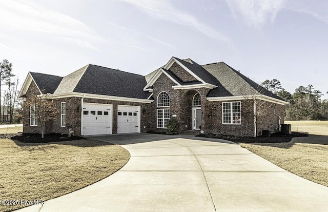 view of front of home with a garage and a front lawn