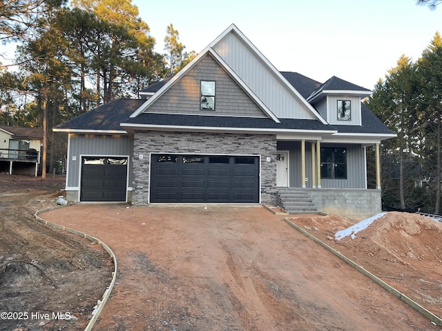 craftsman-style home featuring covered porch and a garage