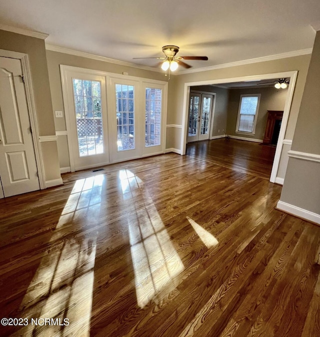 unfurnished room featuring ornamental molding, ceiling fan, french doors, and dark hardwood / wood-style flooring