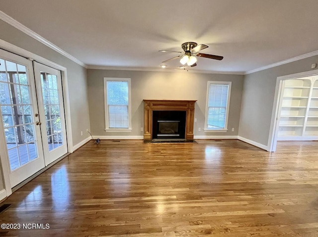 unfurnished living room featuring ceiling fan, dark hardwood / wood-style floors, and crown molding