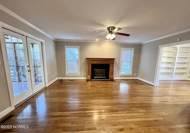 unfurnished living room featuring french doors, a wealth of natural light, ceiling fan, and dark hardwood / wood-style flooring