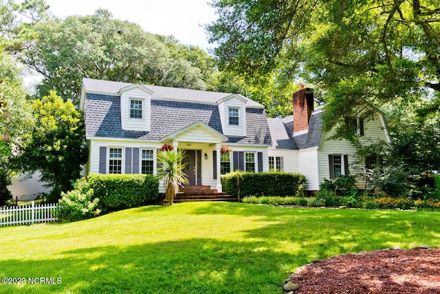 cape cod house featuring a front lawn