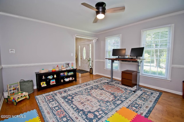 game room featuring ornamental molding, ceiling fan, and dark hardwood / wood-style flooring