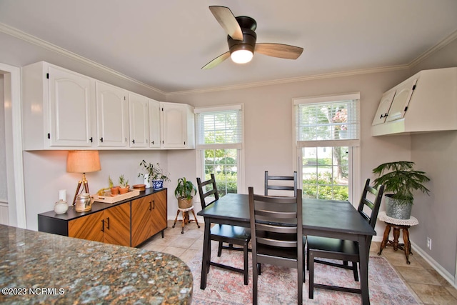 dining room with ceiling fan, crown molding, and light tile flooring