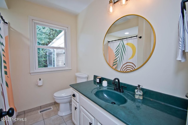 bathroom featuring vanity, tile floors, and toilet