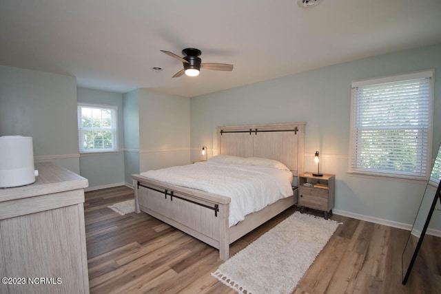 bedroom with ceiling fan and hardwood / wood-style flooring