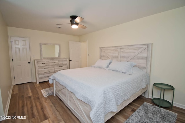 bedroom with ceiling fan and dark wood-type flooring