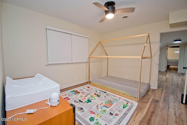 bedroom featuring a closet, ceiling fan, and light wood-type flooring