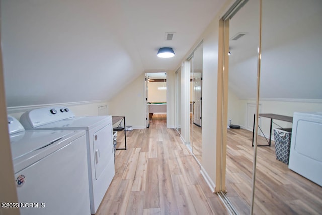 laundry area featuring light hardwood / wood-style flooring and independent washer and dryer