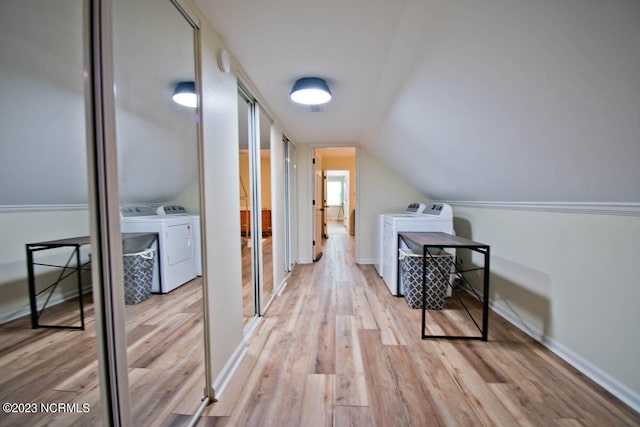 bonus room featuring lofted ceiling, independent washer and dryer, and light wood-type flooring