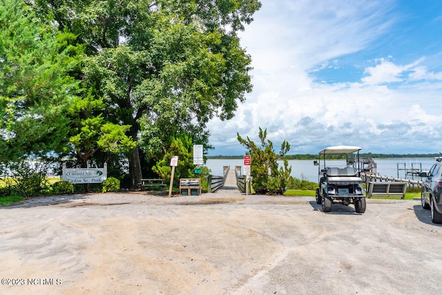 view of patio / terrace with a dock and a water view