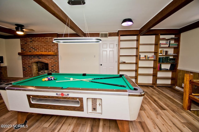 game room with brick wall, ceiling fan, light hardwood / wood-style flooring, a fireplace, and pool table