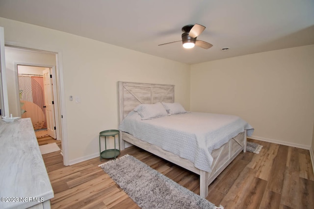 bedroom with light hardwood / wood-style floors and ceiling fan